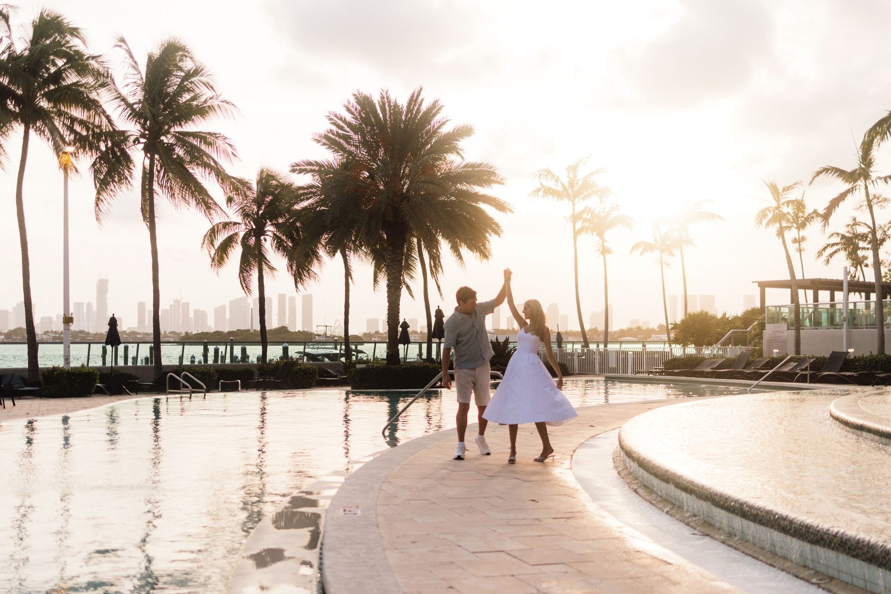 Twirling beside a pool at golden hour